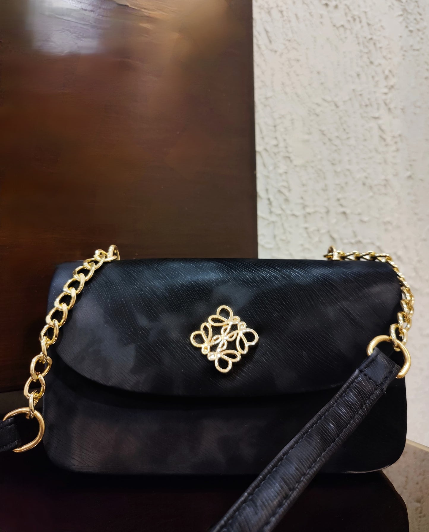 Luxe Quilted Black Evening Bag with Ornate Gold Emblem and Chain Strap